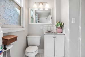 Full bath with vanity, a shower with shower curtain, and backsplash
