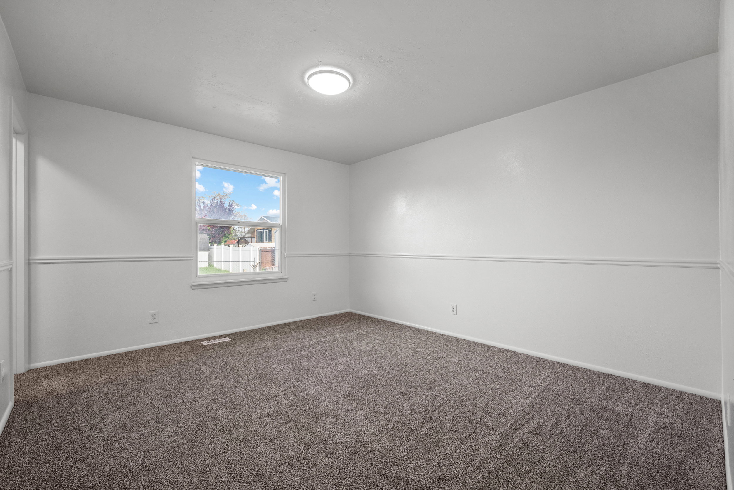 Neutral tone wall paint with decorative chair rail molding