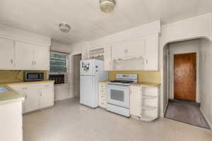 Kitchen featuring white cabinetry and yellow countertops