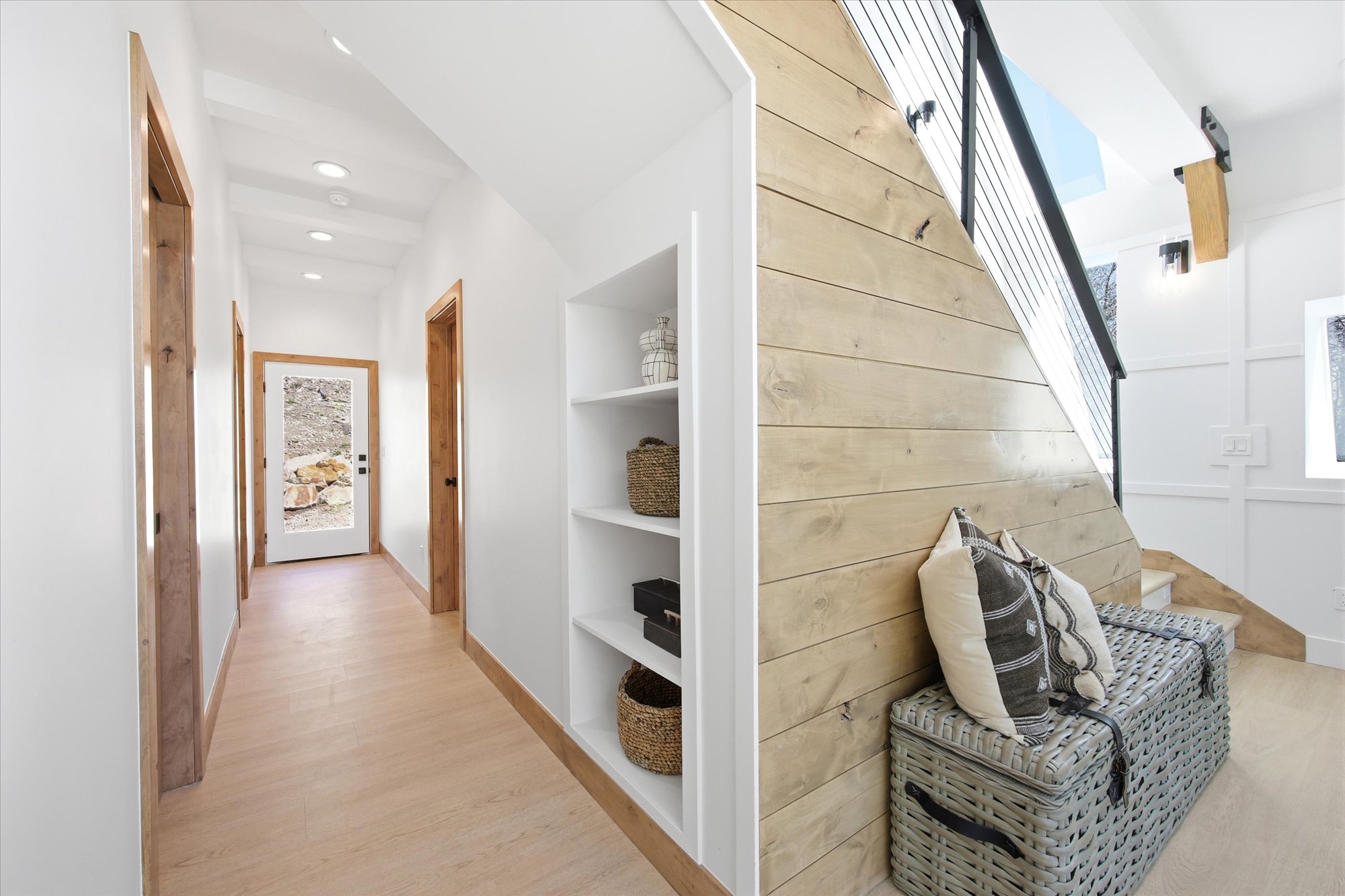 Hallway featuring built-in shelving, recessed ceiling lighting, and light wood-finish flooring