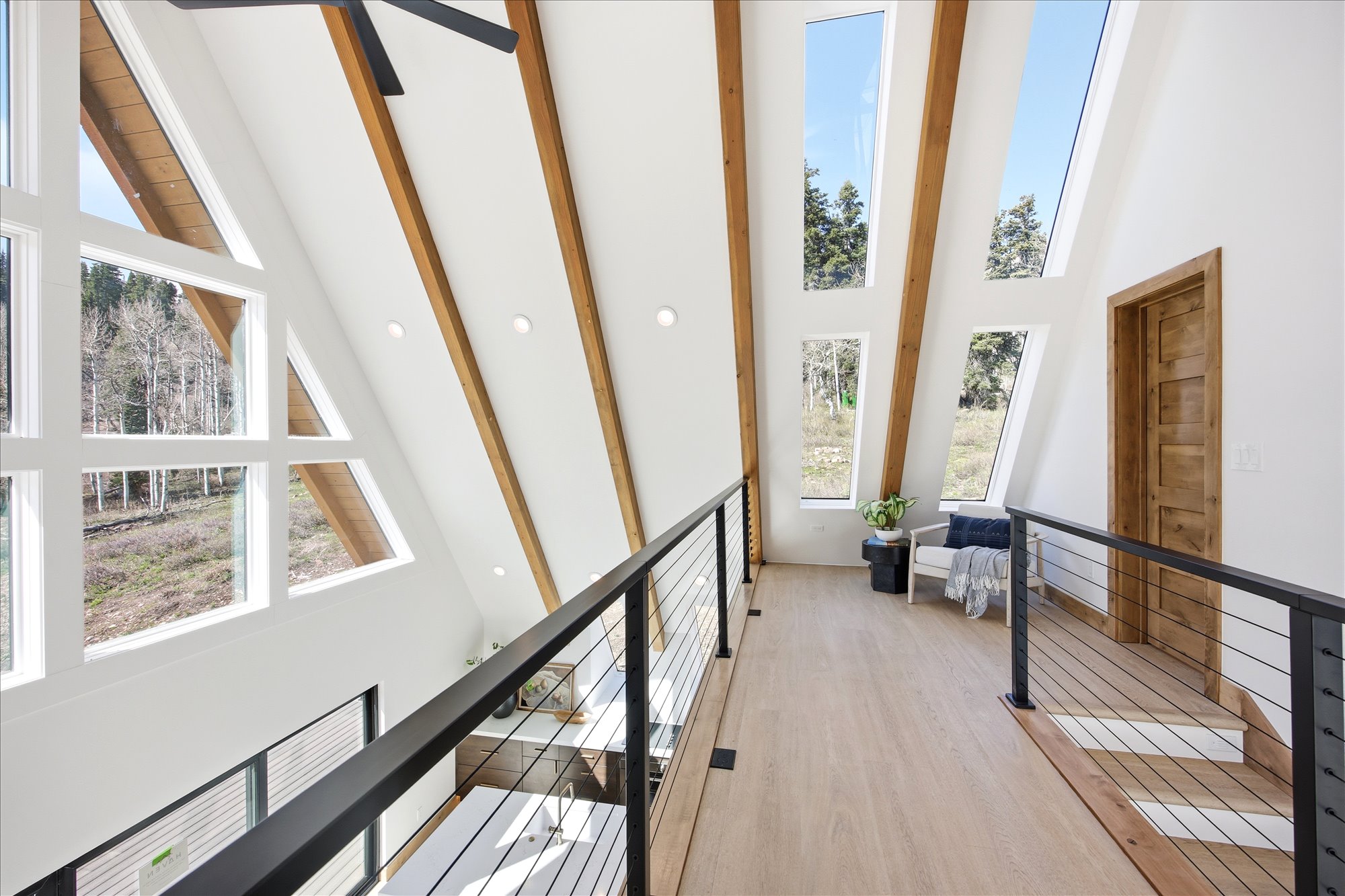 Vaulted ceilings featuring exposed wood beams and recessed lighting