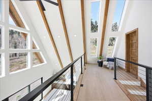 Vaulted ceilings featuring exposed wood beams and recessed lighting