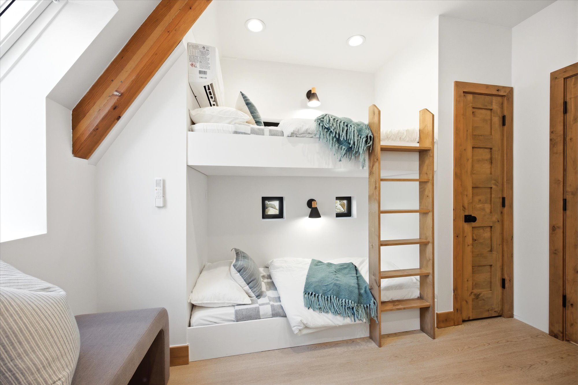 Built-in bunk beds with integrated ladder and individual reading lights