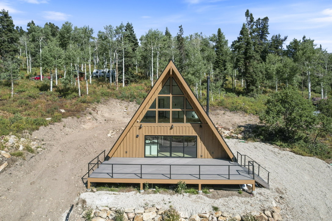 A-frame residence with a triangular window wall and a prominent wood-tone exterior