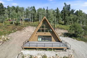 A-frame residence with a triangular window wall and a prominent wood-tone exterior