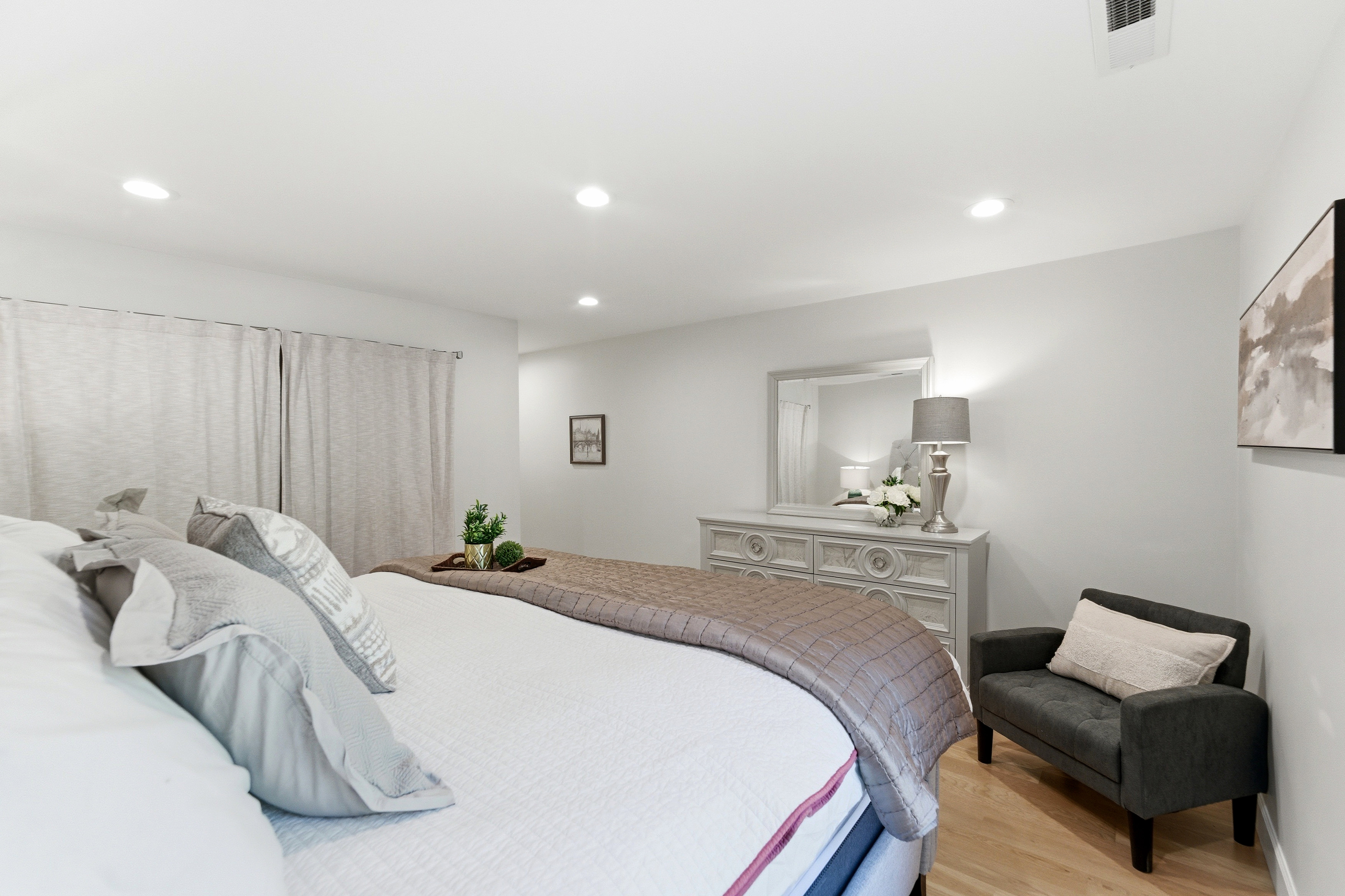 Bedroom featuring light wood-finish flooring, recessed lighting, and white walls