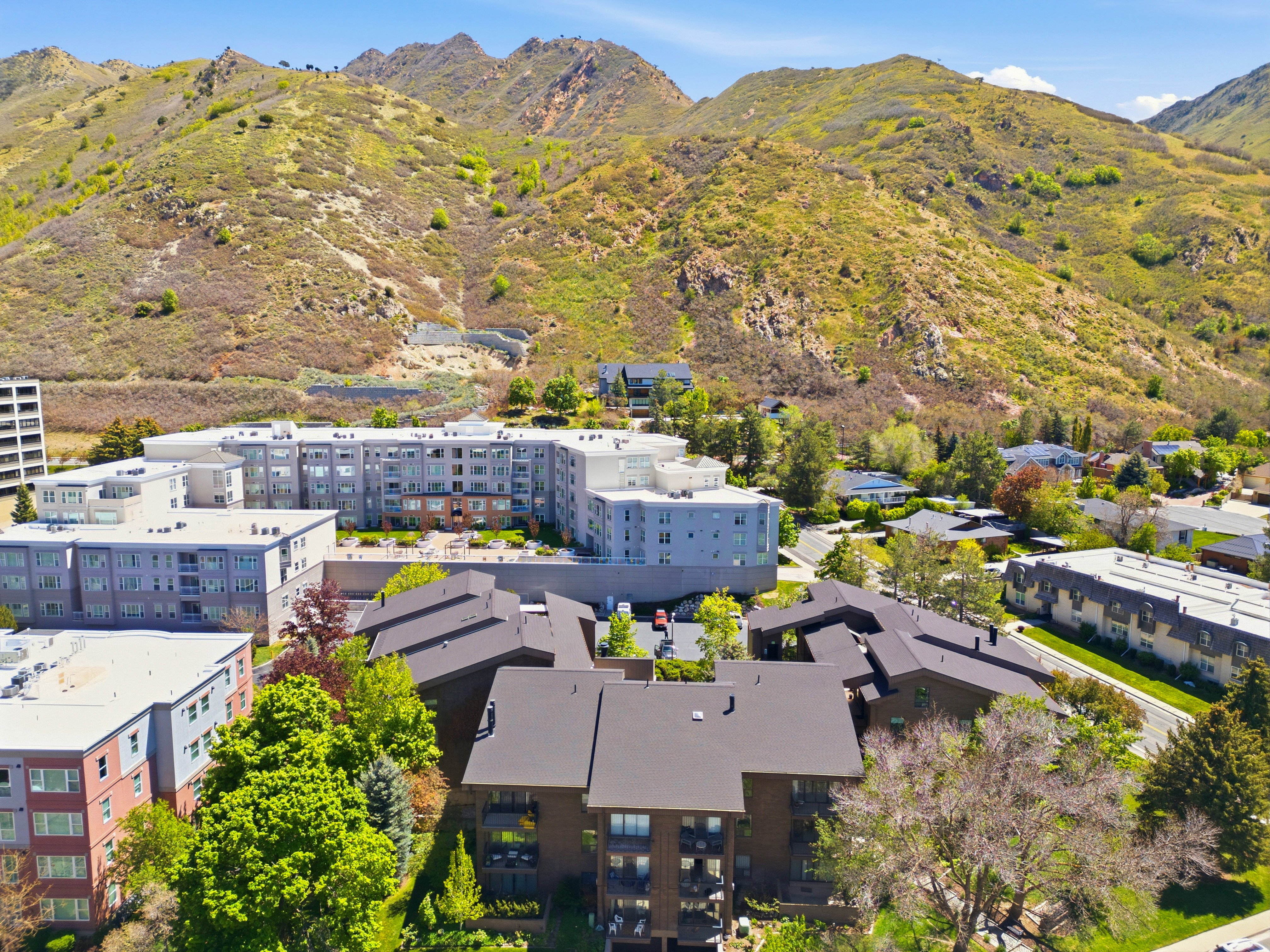 Multi-story residential buildings set against a mountainous backdrop