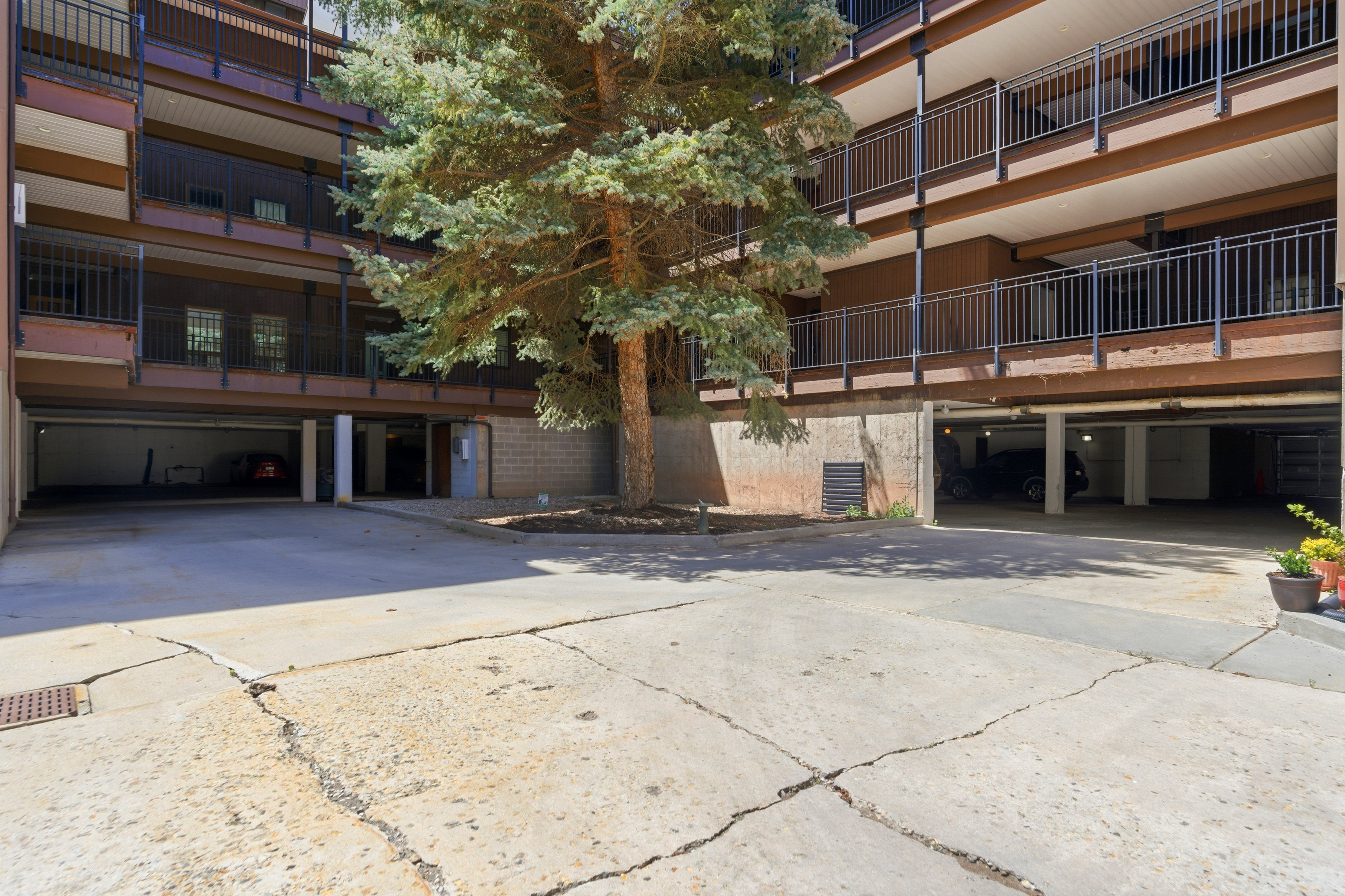 Multi-level building exterior featuring brown siding and black metal railings