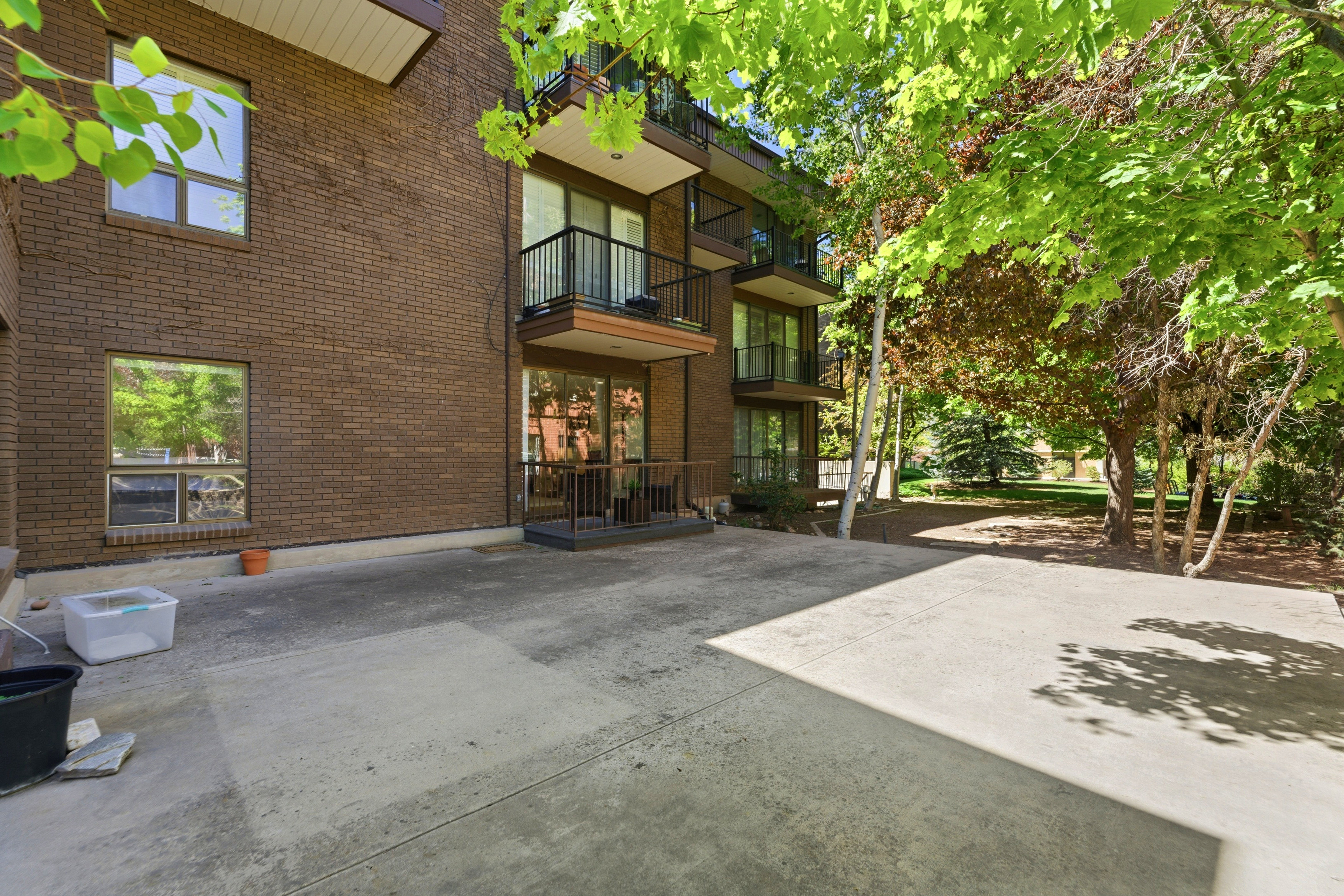Brick exterior building featuring multiple balconies with dark railings