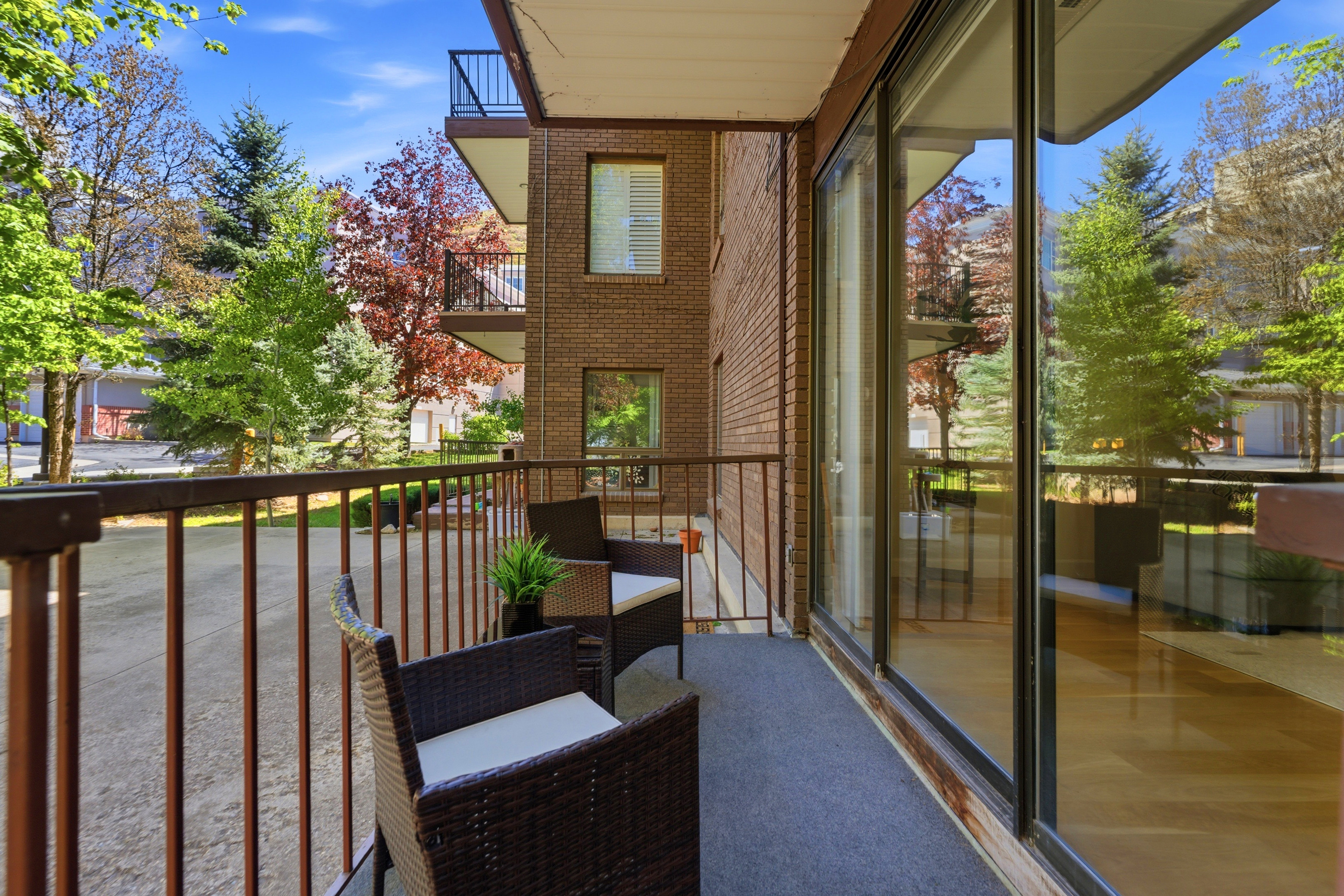 Private balcony with dark metal railings, providing an outdoor extension of the living space