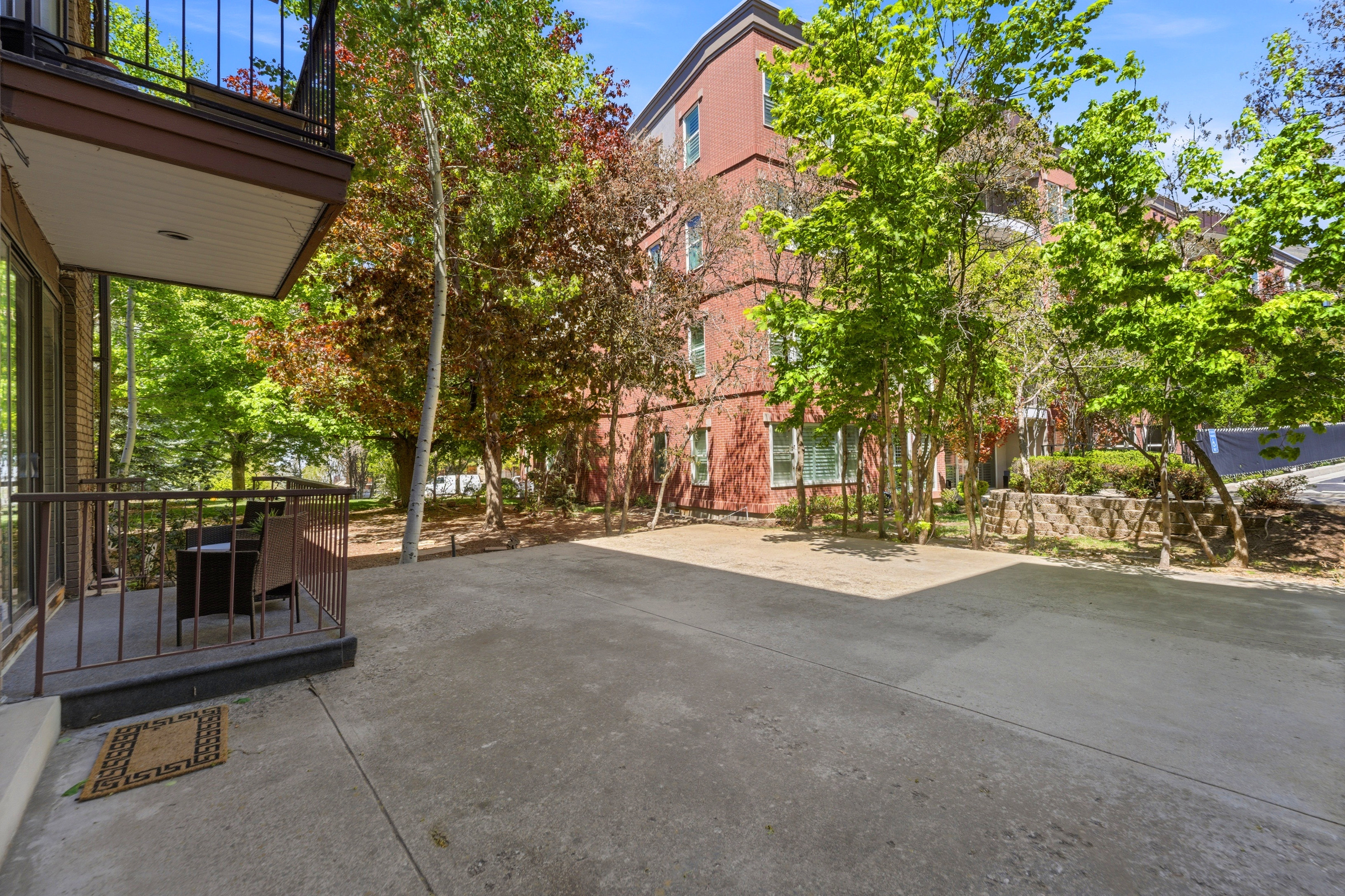 Ground-level concrete patio providing ample outdoor space