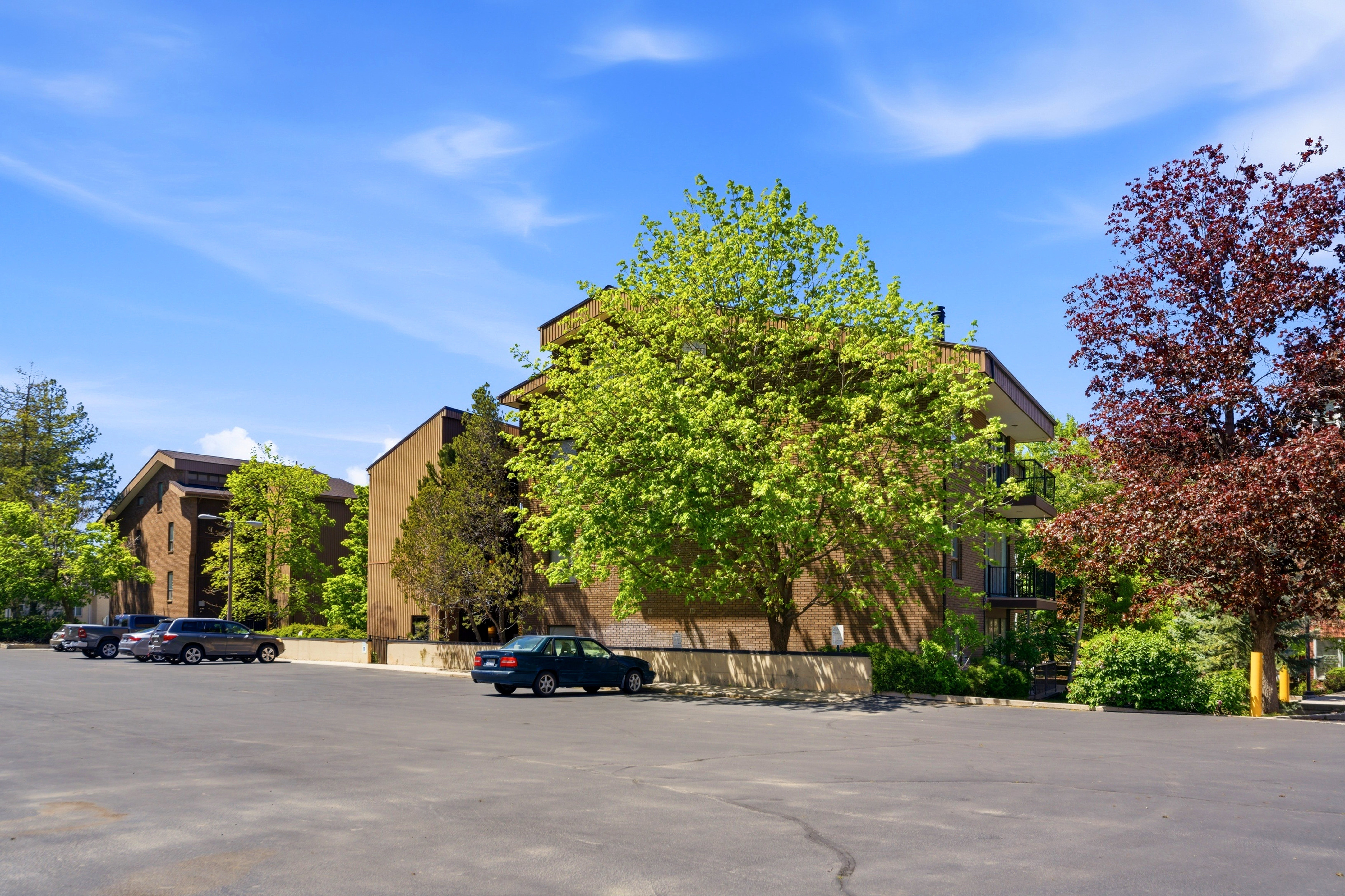 Multi-story building featuring brick-finish exterior and private balconies