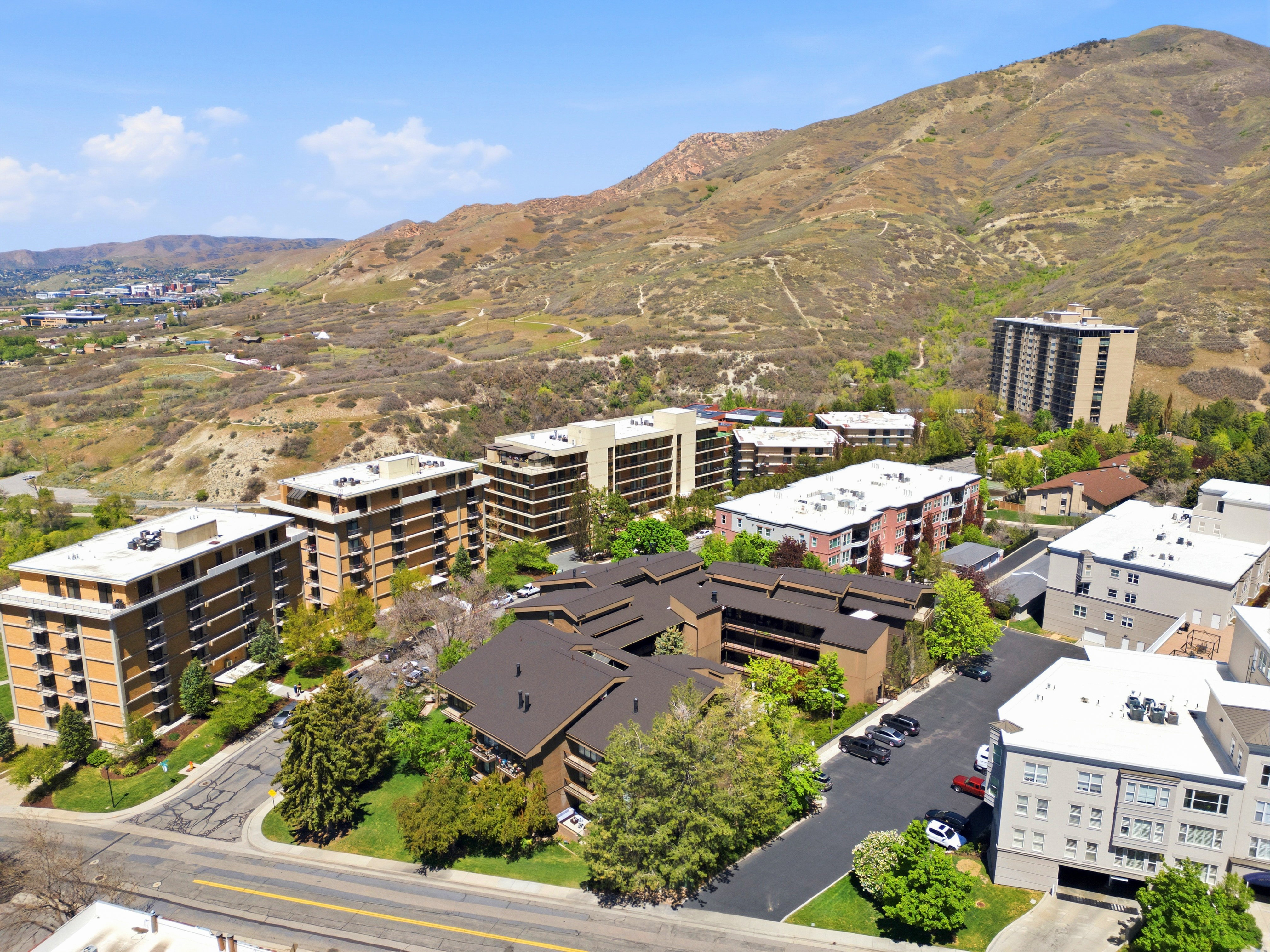 Aerial perspective showcasing a collection of multi-story buildings, some featuring brick facades and balconies