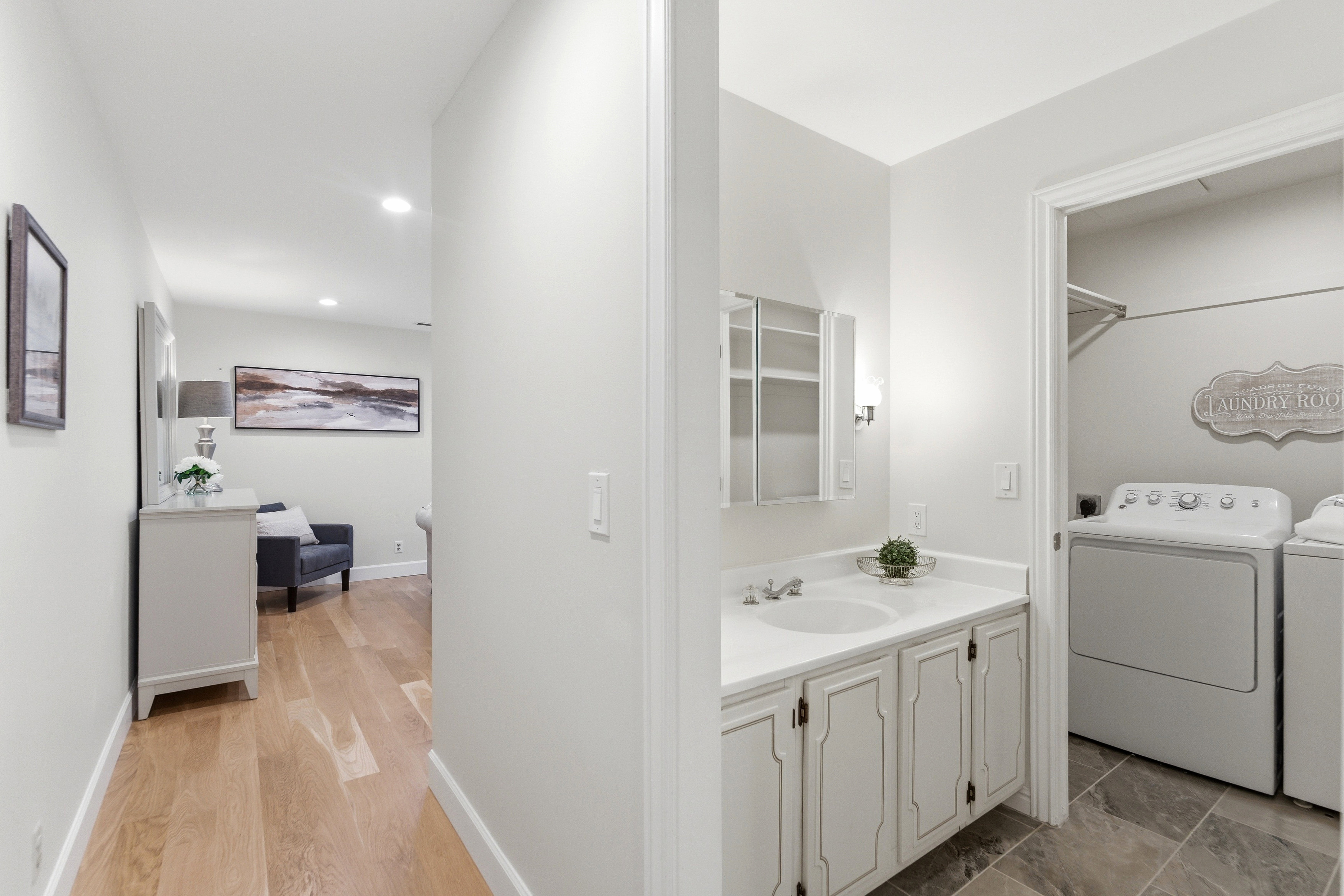 Laundry area with tile flooring and shelving