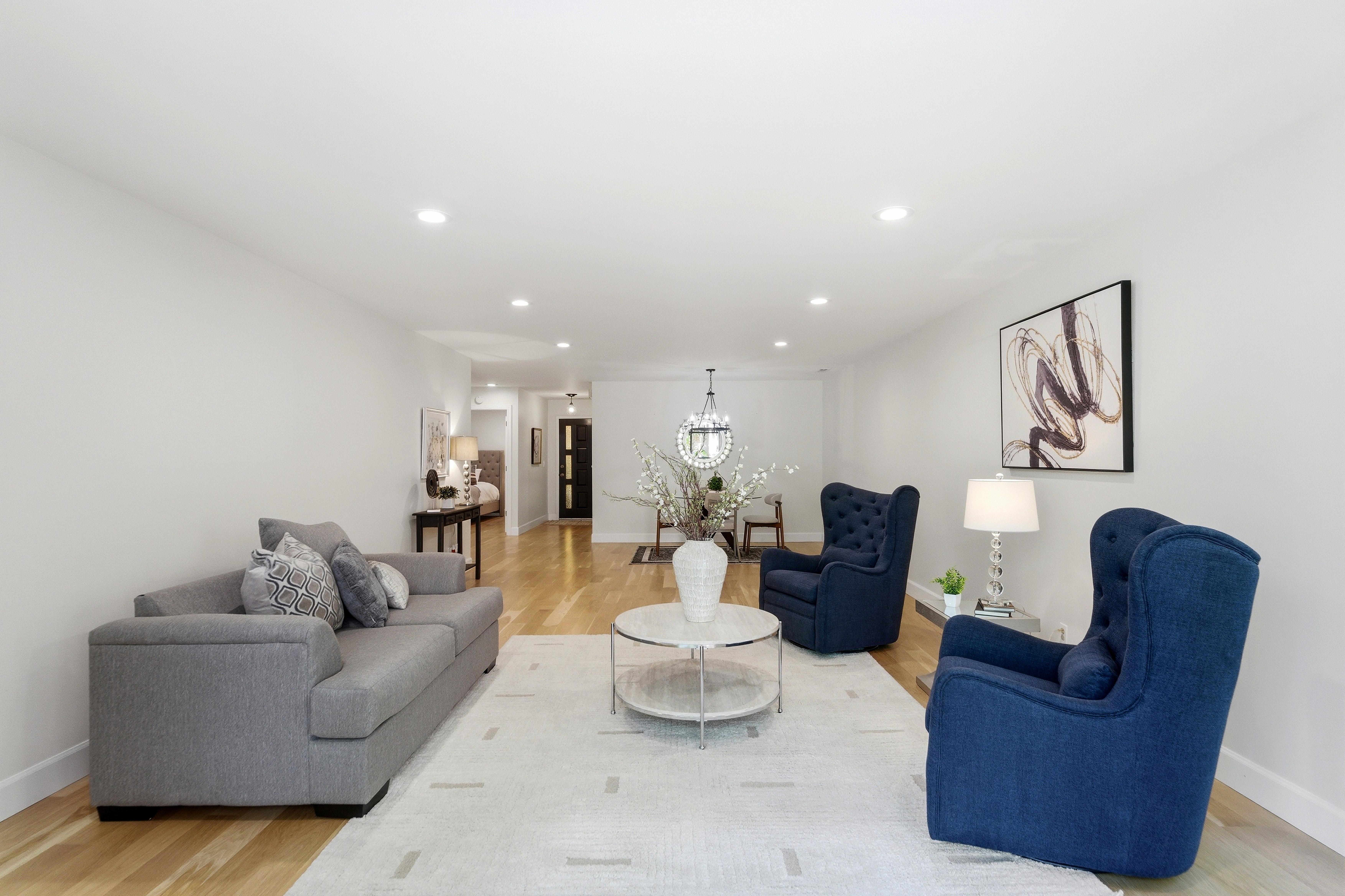 Bright living space featuring recessed lighting, light wood-finish flooring, and white baseboards