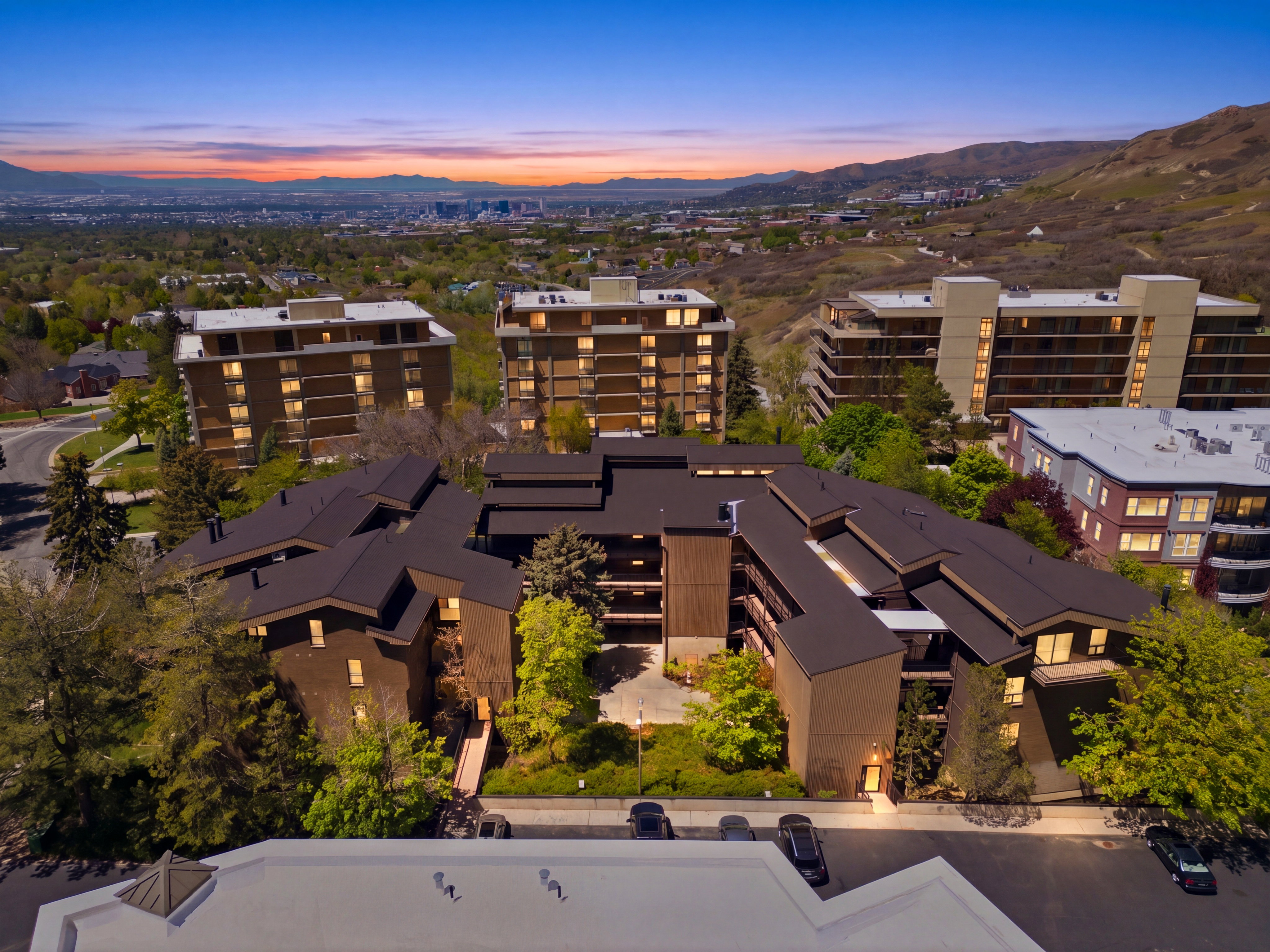 Contemporary multi-story building featuring a dark roofline and numerous windows