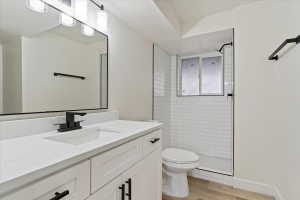 Bathroom featuring a vanity with a white countertop and undermount sink, matte black faucet, and white cabinetry