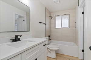 Modern bathroom featuring a white vanity with integrated sink, a quartz-finish countertop, and matte black fixtures