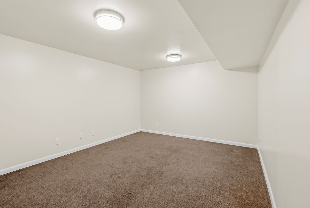 Carpeted spare room with baseboards