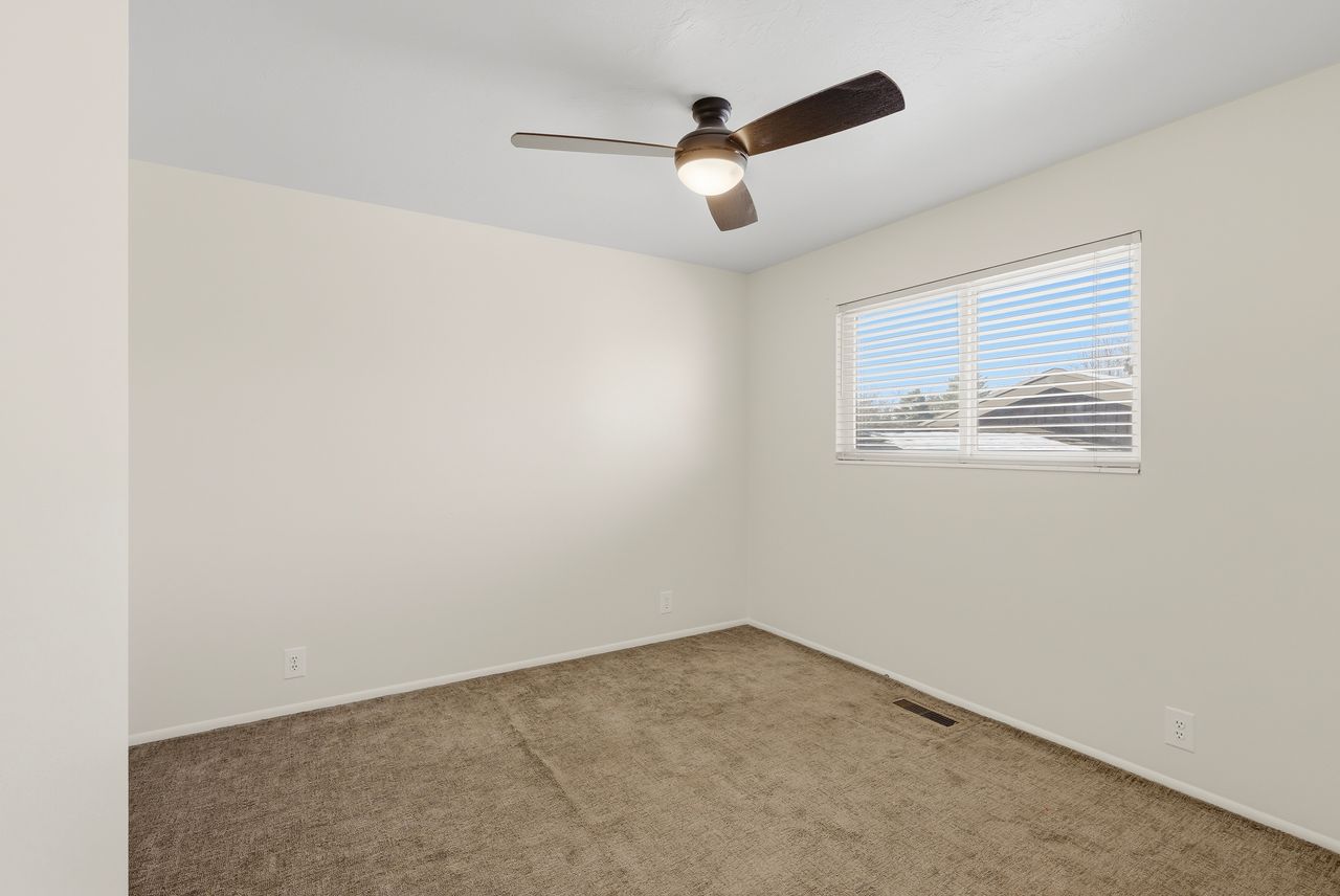 Spare room with carpet and ceiling fan