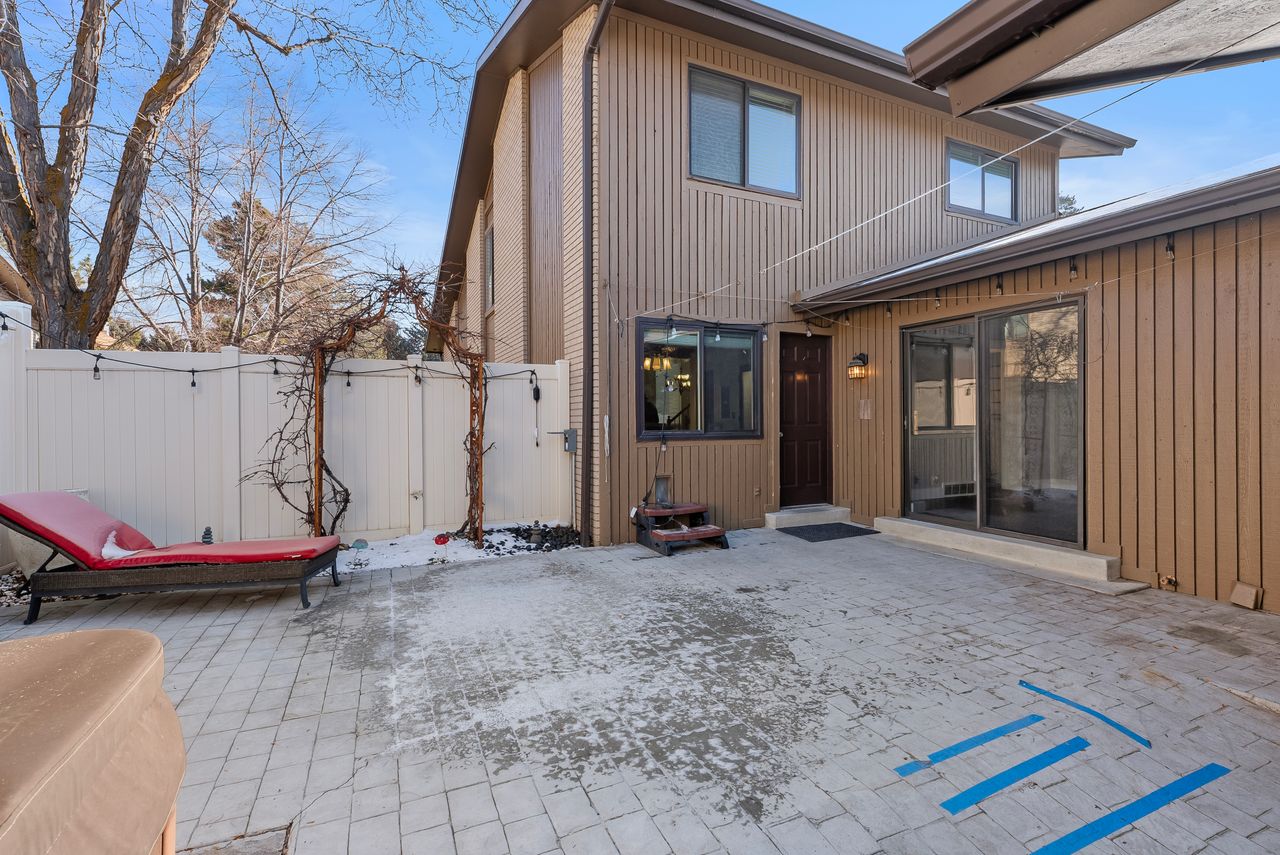 Rear view of property featuring a gate and a patio