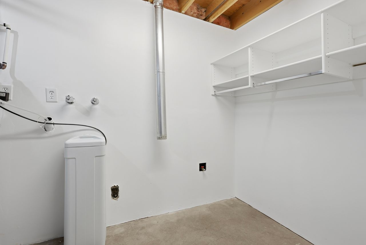 Laundry area with concrete flooring