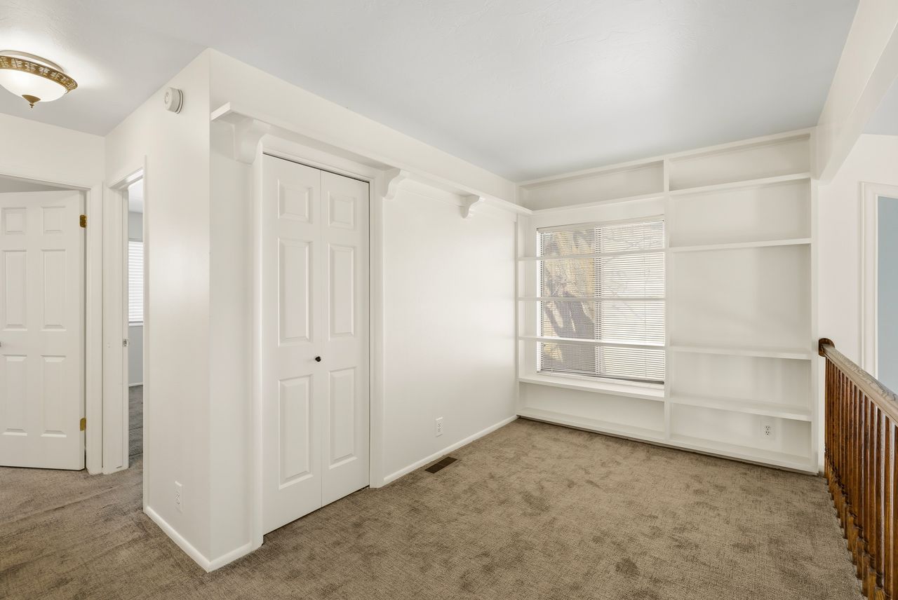 Unfurnished bedroom with dark colored carpet and a closet