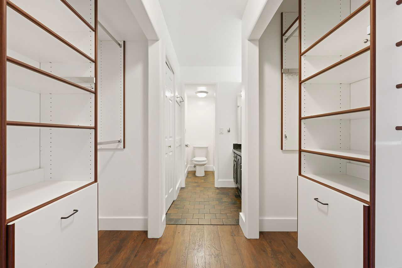 Hallway with baseboards and dark wood-style floors