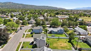 Residential neighborhood featuring mature trees and mountain backdrops