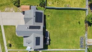 Shingle roof featuring multiple solar panel installations