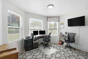 Bright interior space featuring multiple windows, neutral wall tones, and recessed lighting