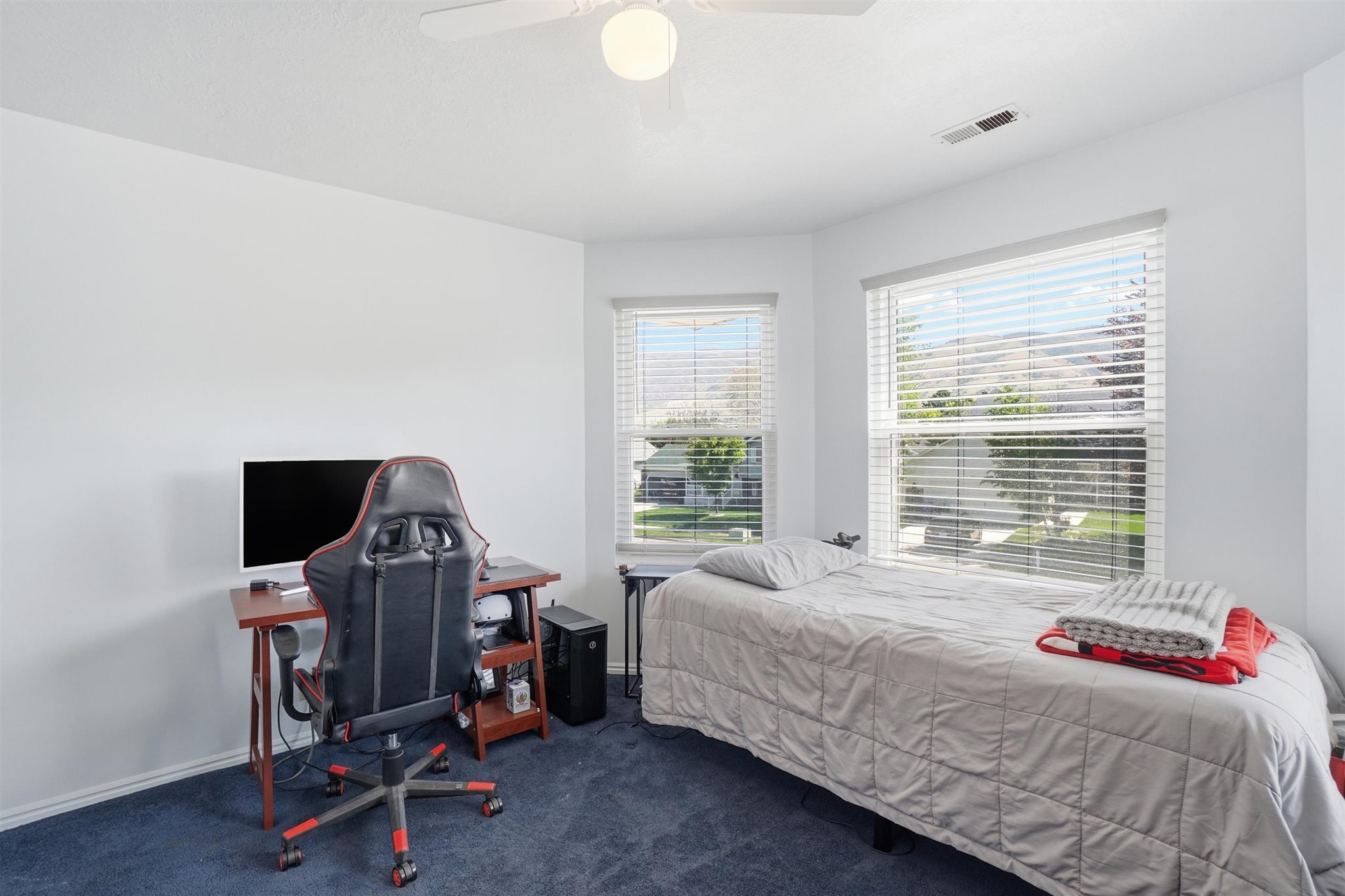 White walls with blue carpet flooring