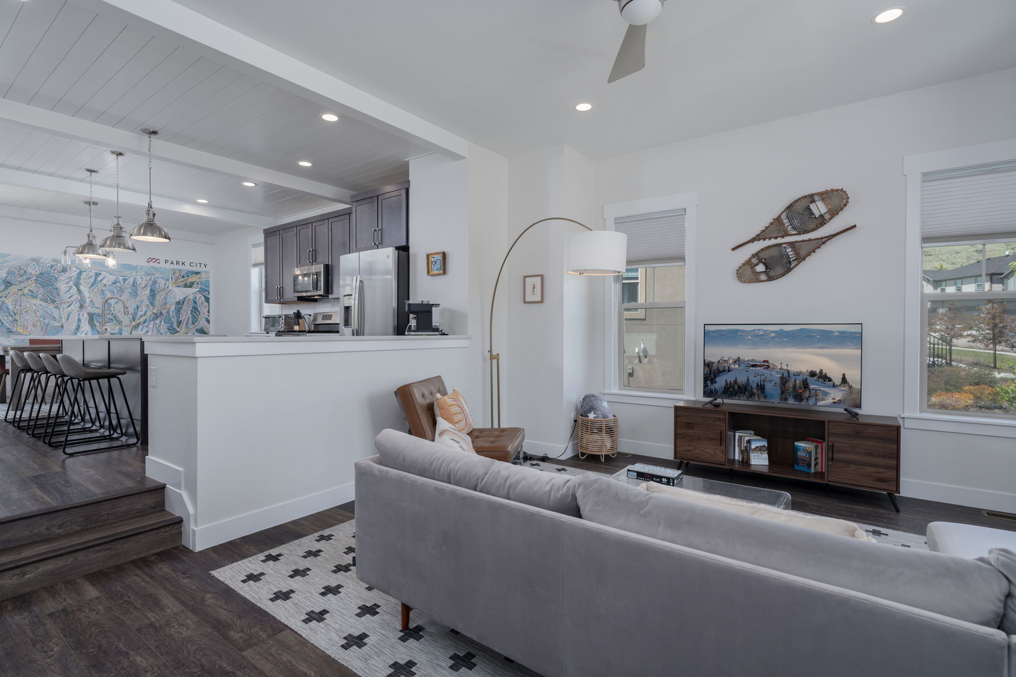 Living room featuring dark wood-style flooring, a ceiling fan, beamed ceiling, and recessed lighting