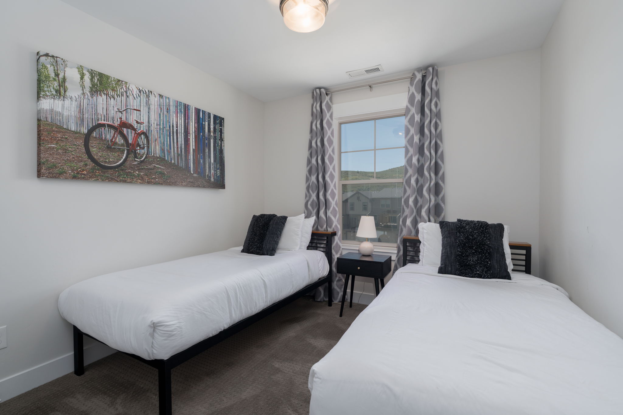 Bedroom featuring dark carpet and baseboards
