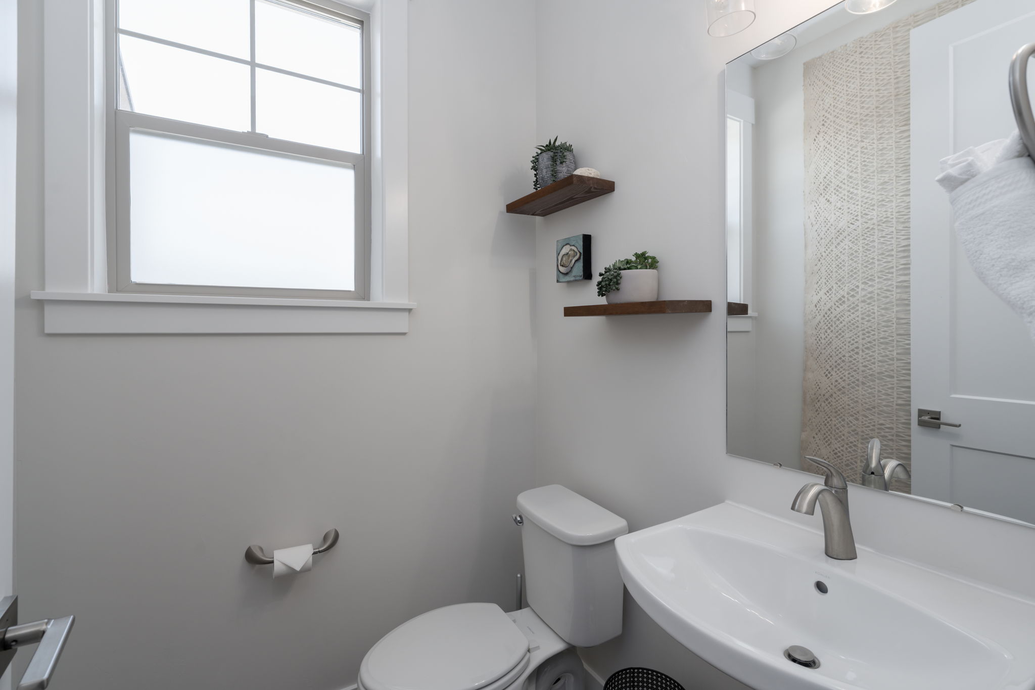Half bathroom featuring a sink and toilet