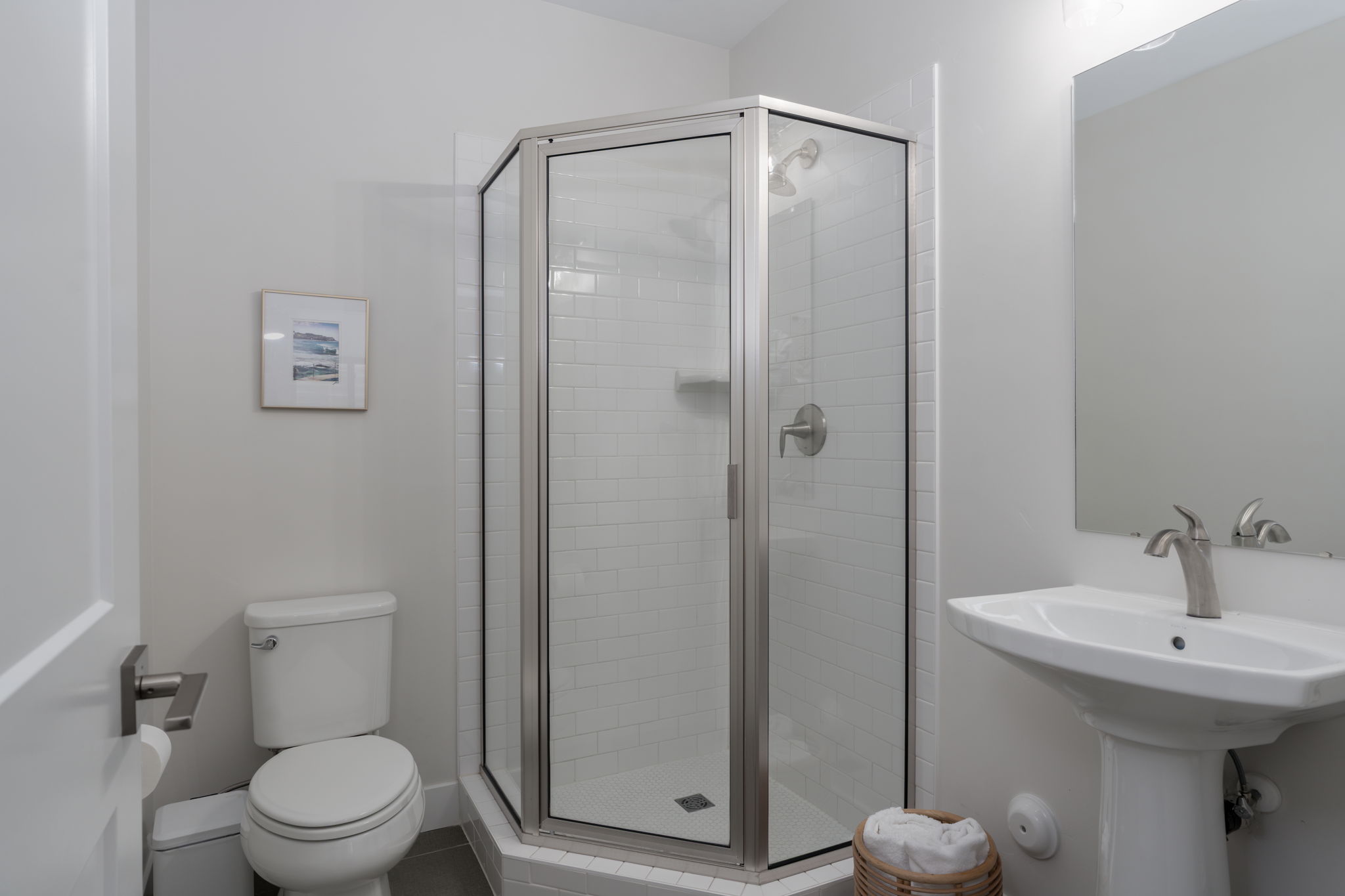 Bathroom featuring toilet and a stall shower