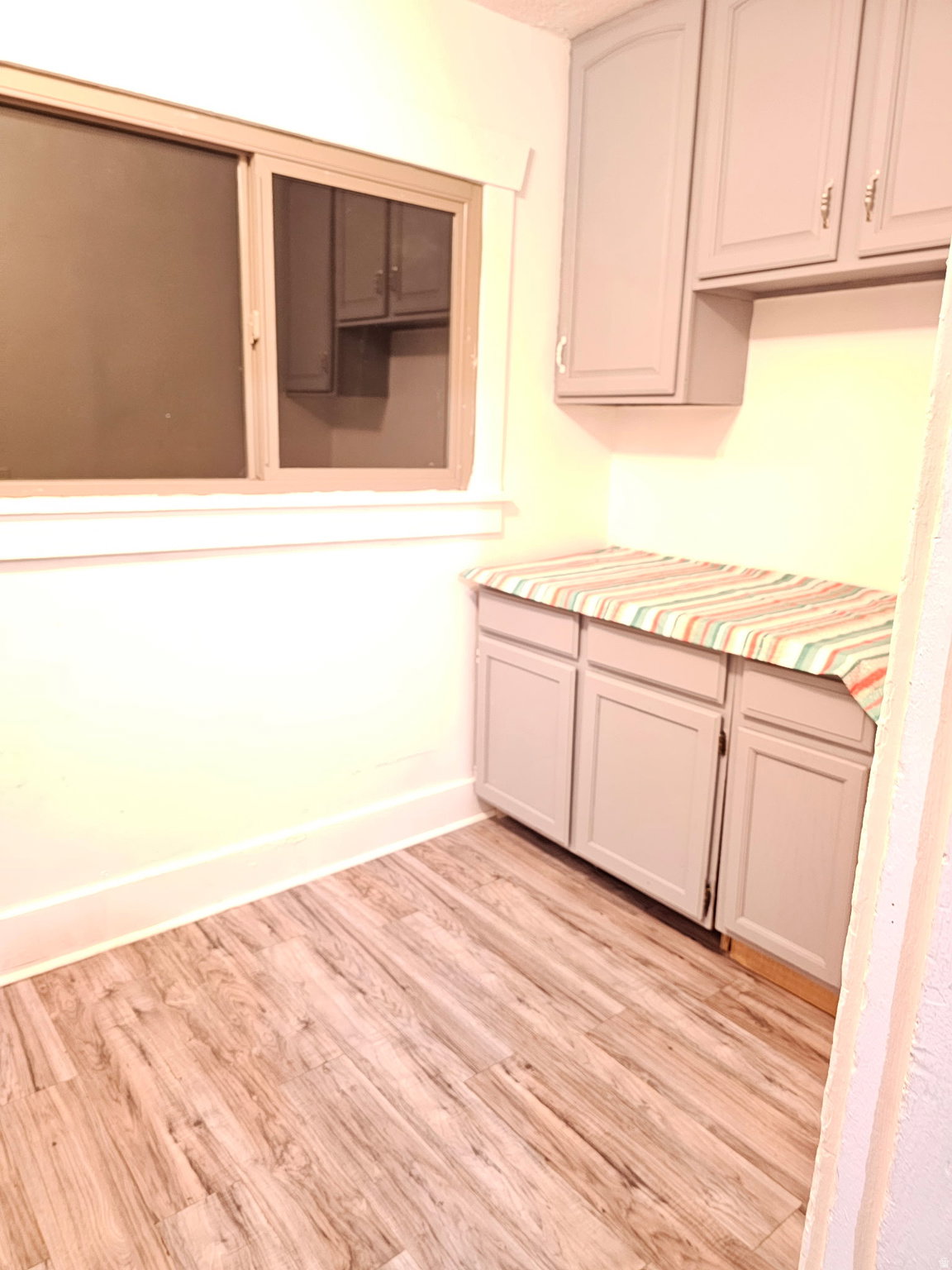 Kitchen with light wood finished floors and light countertops