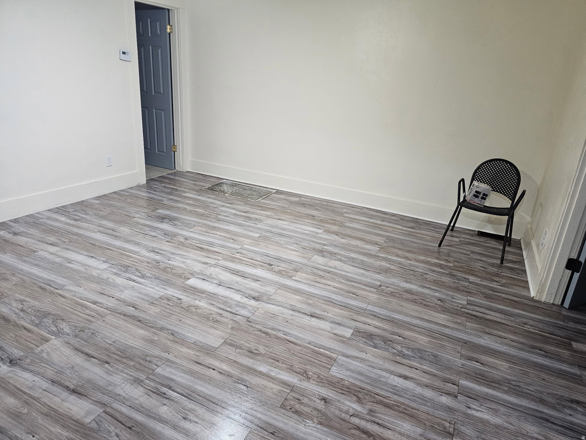 Unfurnished room with light wood-style flooring and baseboards