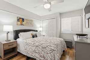 Bedroom featuring wood finished floors, a closet, and ceiling fan