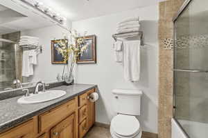 Full bathroom featuring vanity, a textured ceiling, and tiled shower / bath combo