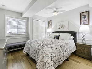 Bedroom featuring a closet, hardwood / wood-style flooring, and a ceiling fan