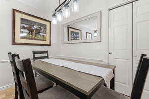 Dining area with light wood-type flooring and baseboards