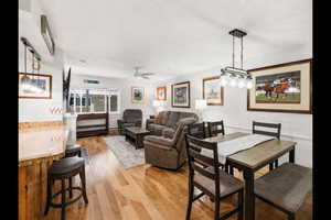 Dining room with light wood-type flooring and a ceiling fan