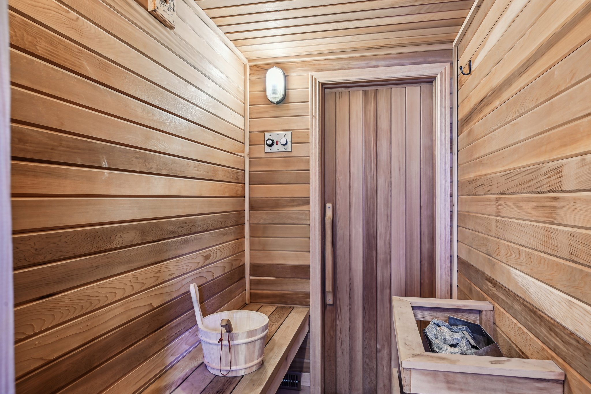 Relaxing sauna / steam room with wooden walls and wooden ceiling