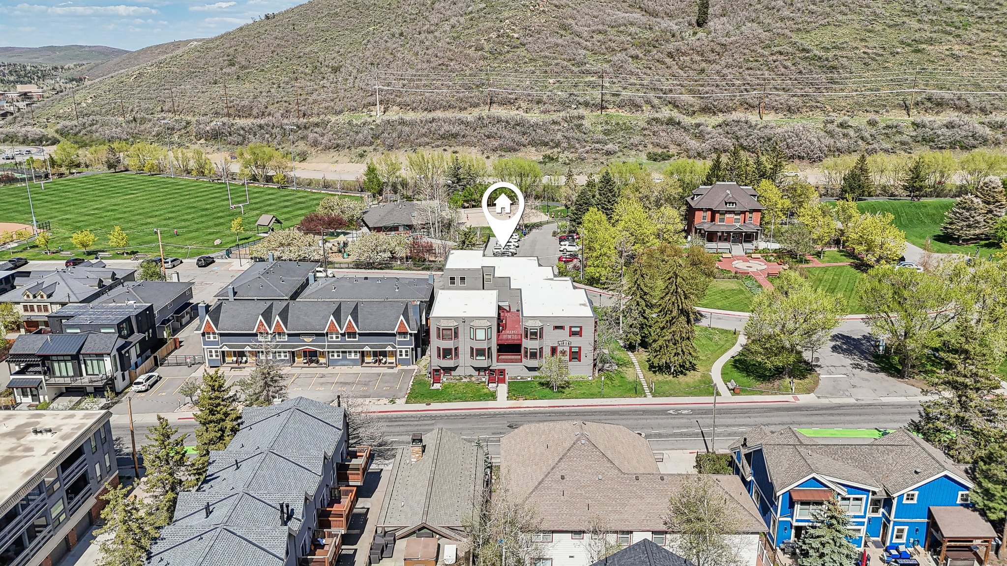 Aerial perspective of suburban area with a mountainous background