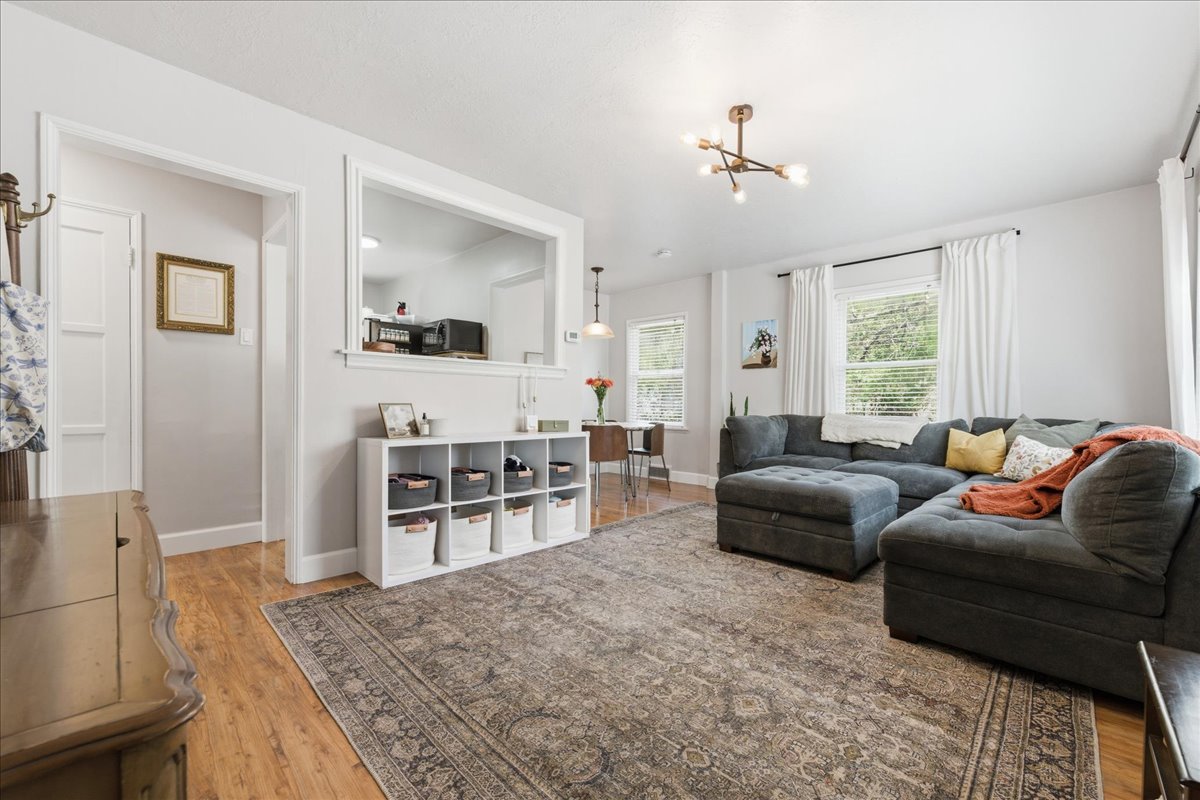 Living room with light wood-style floors and a chandelier