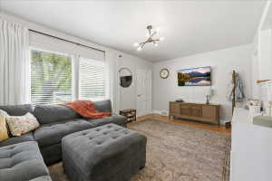 Living area with wood finished floors and hanging lights