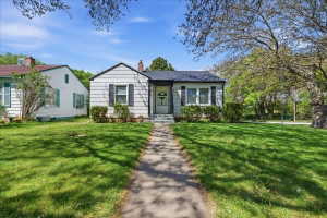 Bungalow with a front lawn and a chimney