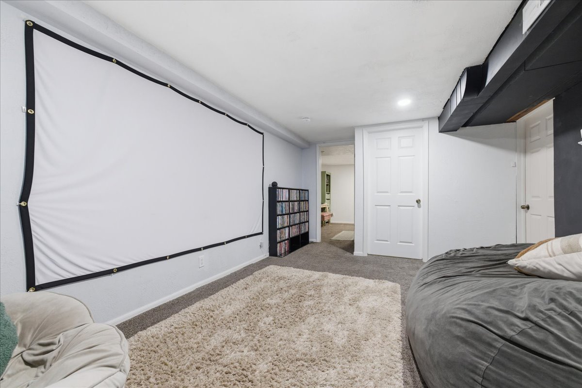 Carpeted cinema room with baseboards