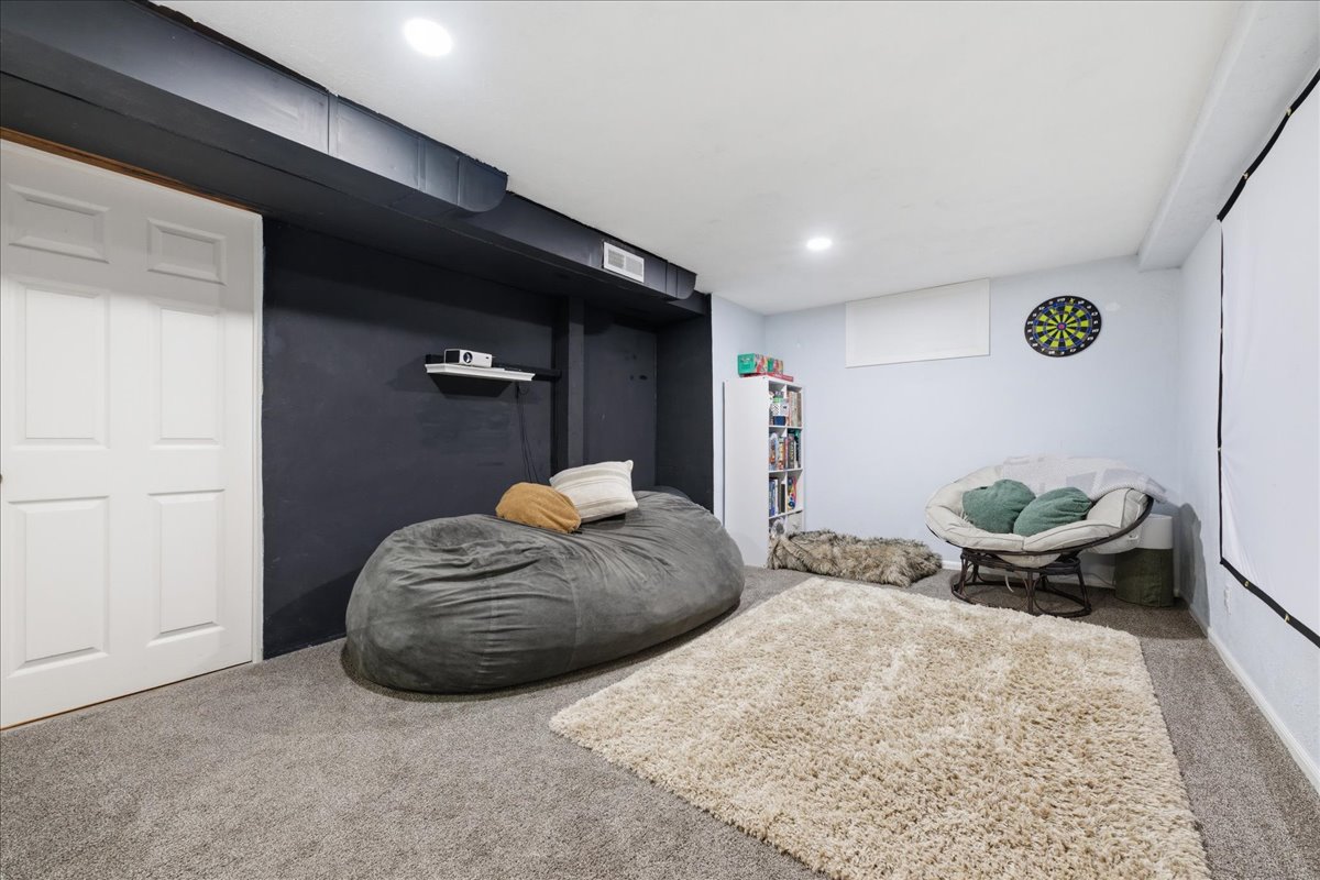 Sitting room with carpet flooring and recessed lighting